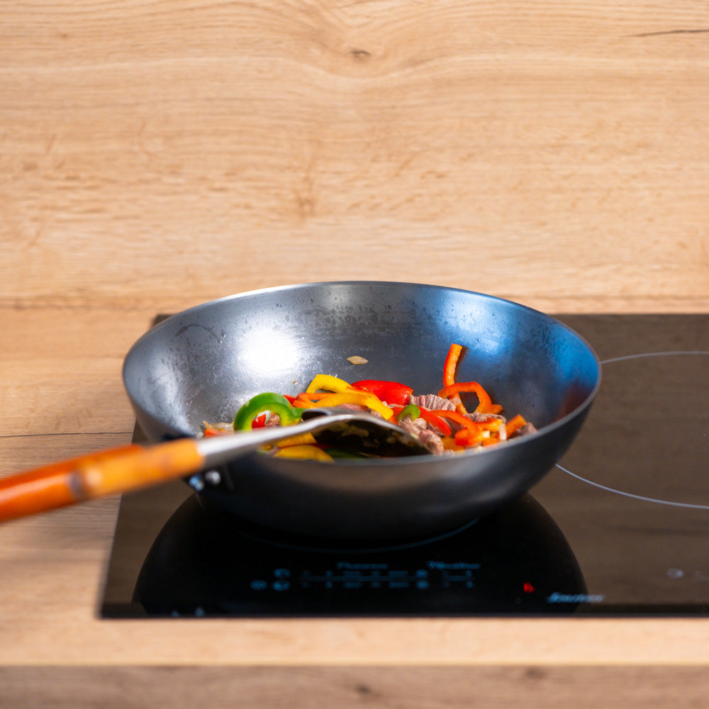 Le Oniri Wok 32 cm Verpackung mit komplettem Gusseisen-Lieferumfang