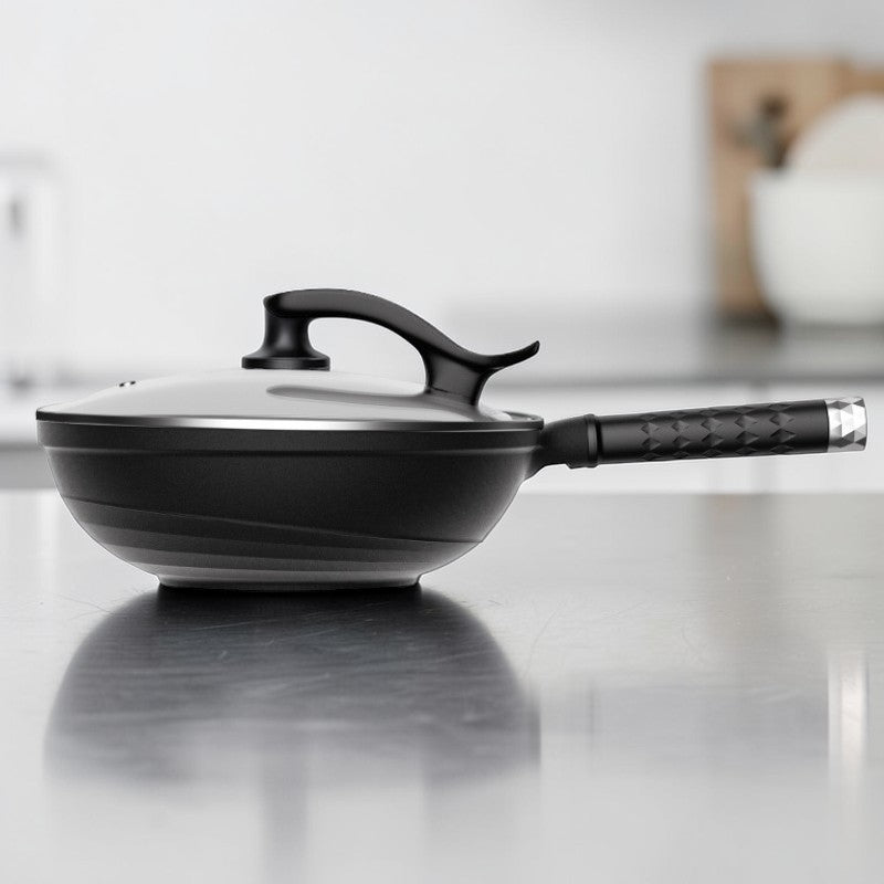 Le Takino Edelstahl Wok in Anwendung auf glattem Ceranfeld